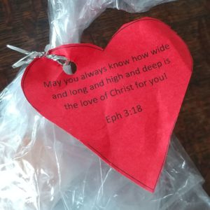 Red heart shaped tag with Ephesians 3:18 blessing on it