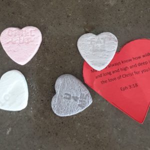 A red heart shaped tag with a blessing based on Eph 3:18, with 4 Conversation Heart Lollies