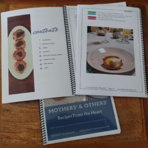 recipe book open at contents and another showing a picture with special dietary symbols